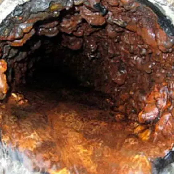 A partially blocked residential sewer pipe, the kind of buildup that drives frequent sewer backups.