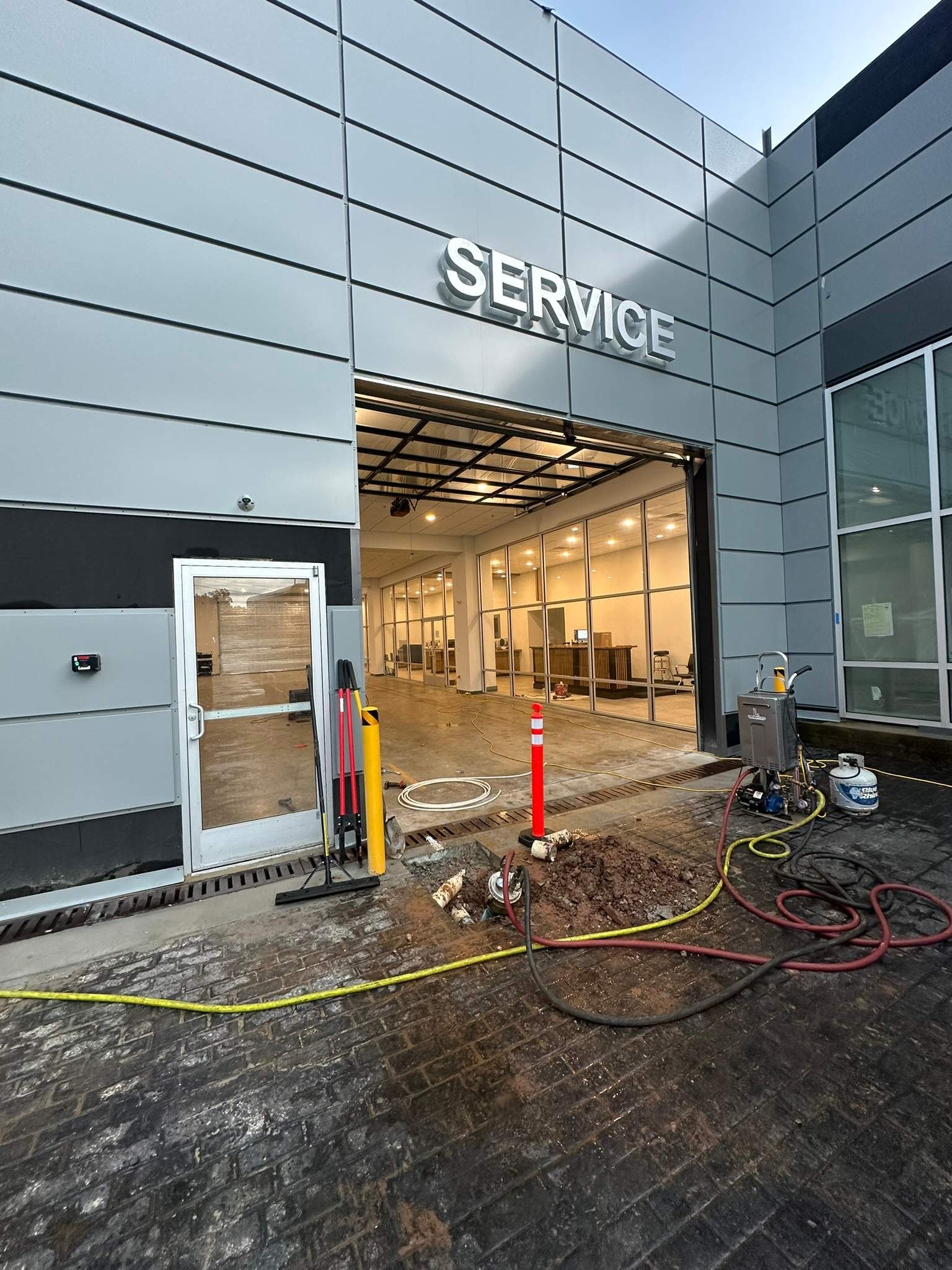 LiningWorks Trenchless Pipe Repair & Sewer Pipe Lining performing trenchless pipe repair at a commercial service bay