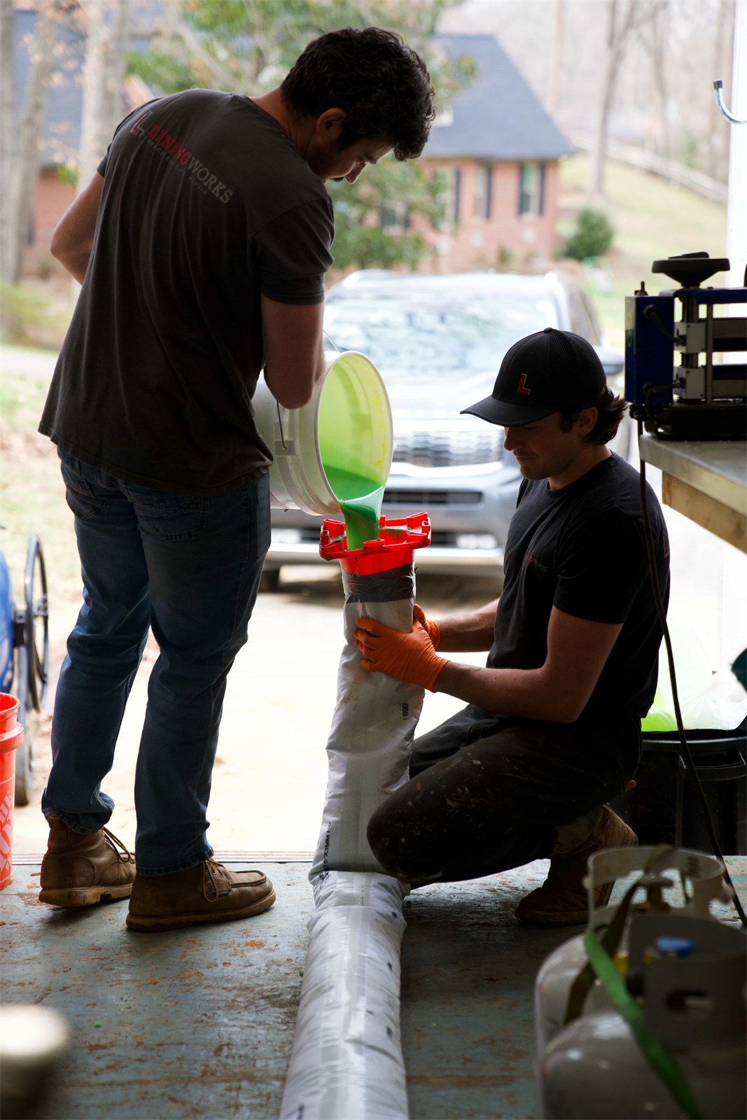 LiningWorks crew saturating a CIPP liner with epoxy resin before it is inverted into the host pipe.
