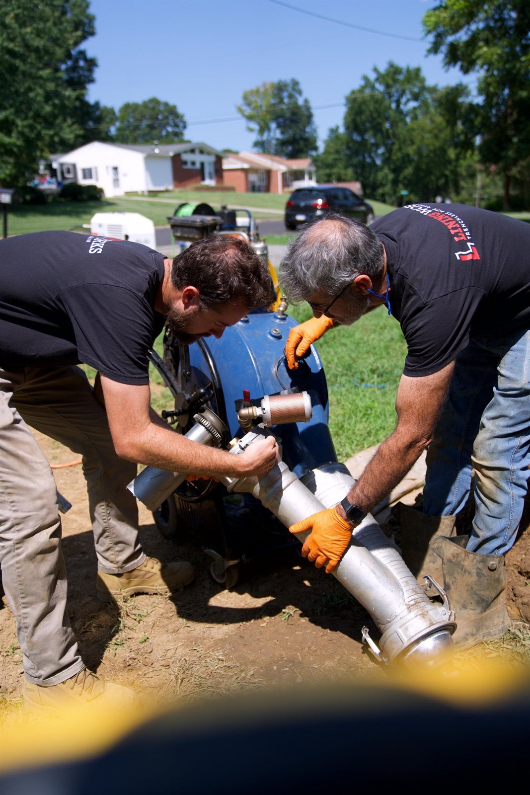 LiningWorks crew members setting up pipe lining equipment to seal the source of a sewer odor.