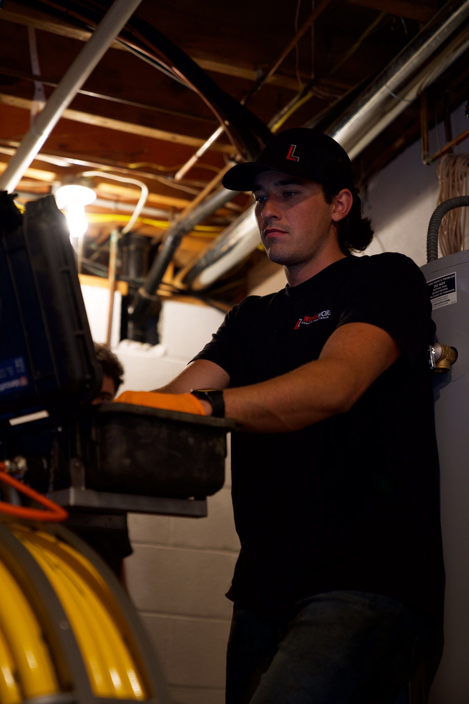 LiningWorks technician running a sewer camera inspection at a Charlotte residential cleanout.