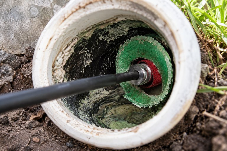 Cutter head entering a sewer cleanout to reopen a blocked connection.