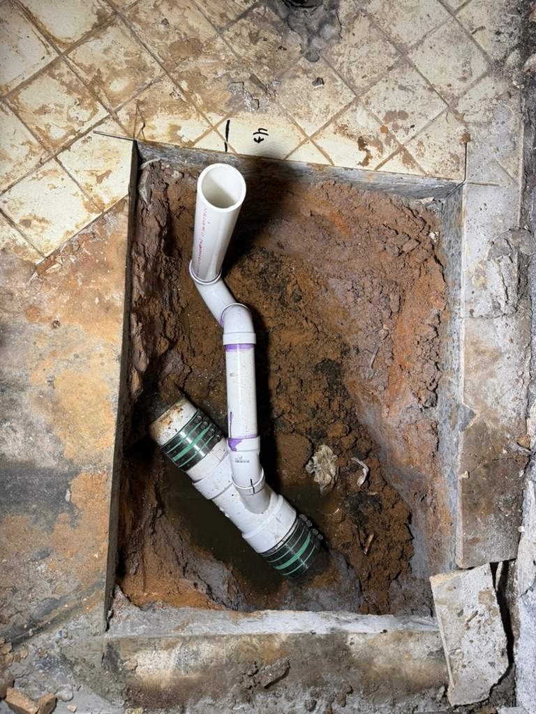 LiningWorks installing a new PVC drain section during a targeted sewer pipe repair in Winston-Salem, NC.