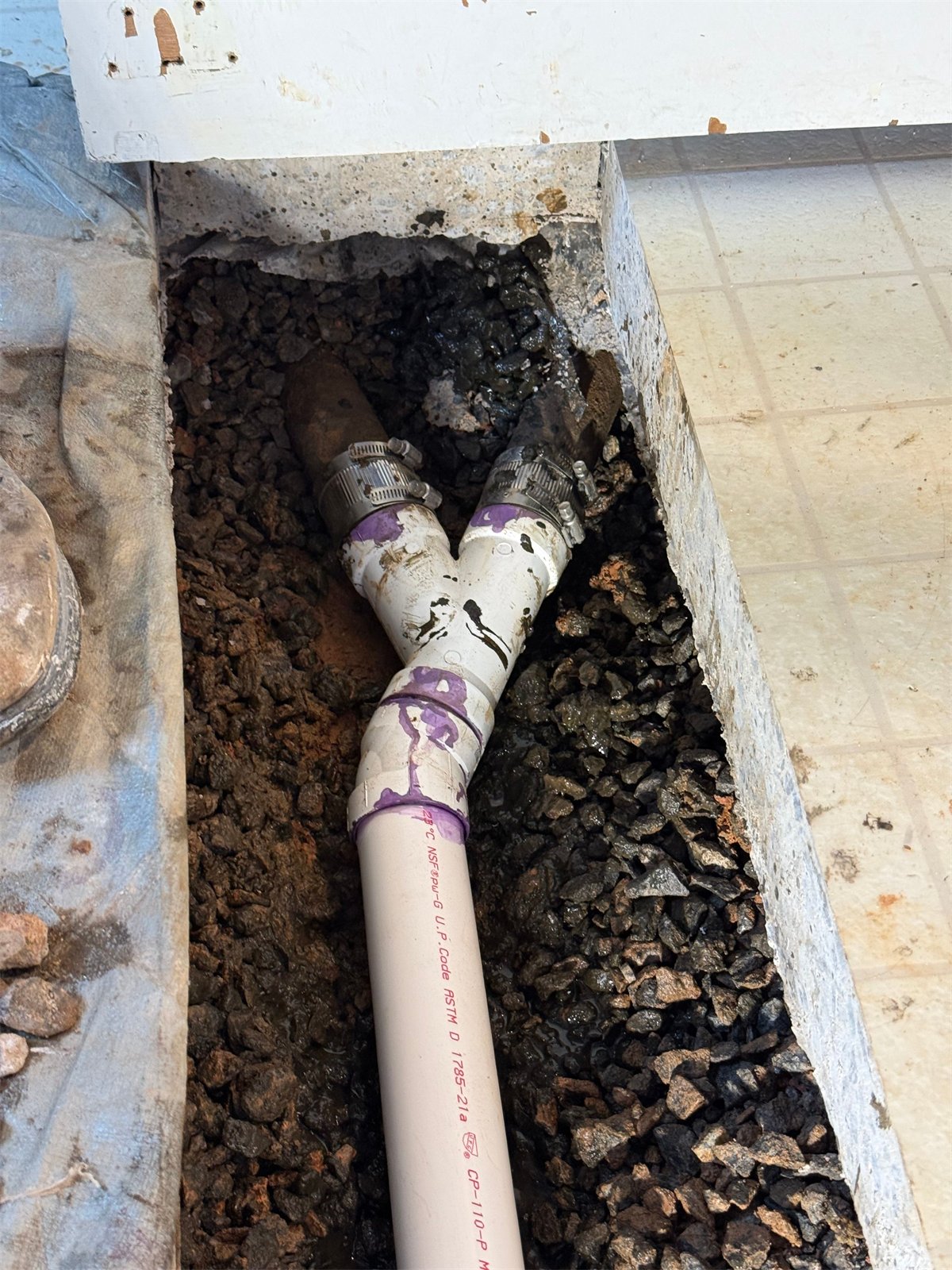 LiningWorks crew completing a pipe repair, joining new PVC to existing cast iron.