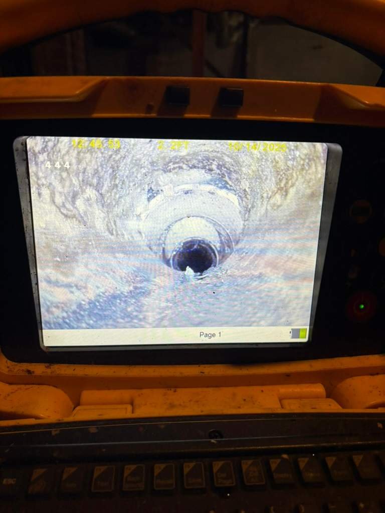 LiningWorks technician running a sewer camera to confirm the line is clear after a jetting pass.
