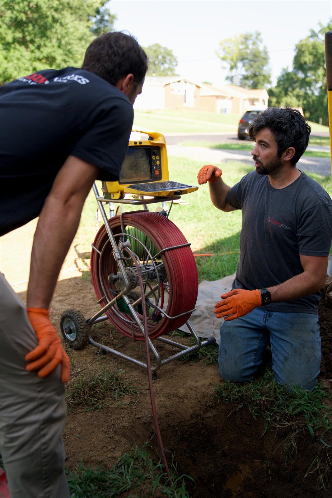 LiningWorks technicians running a sewer camera inspection to confirm whether trenchless sewer line replacement is the right call.