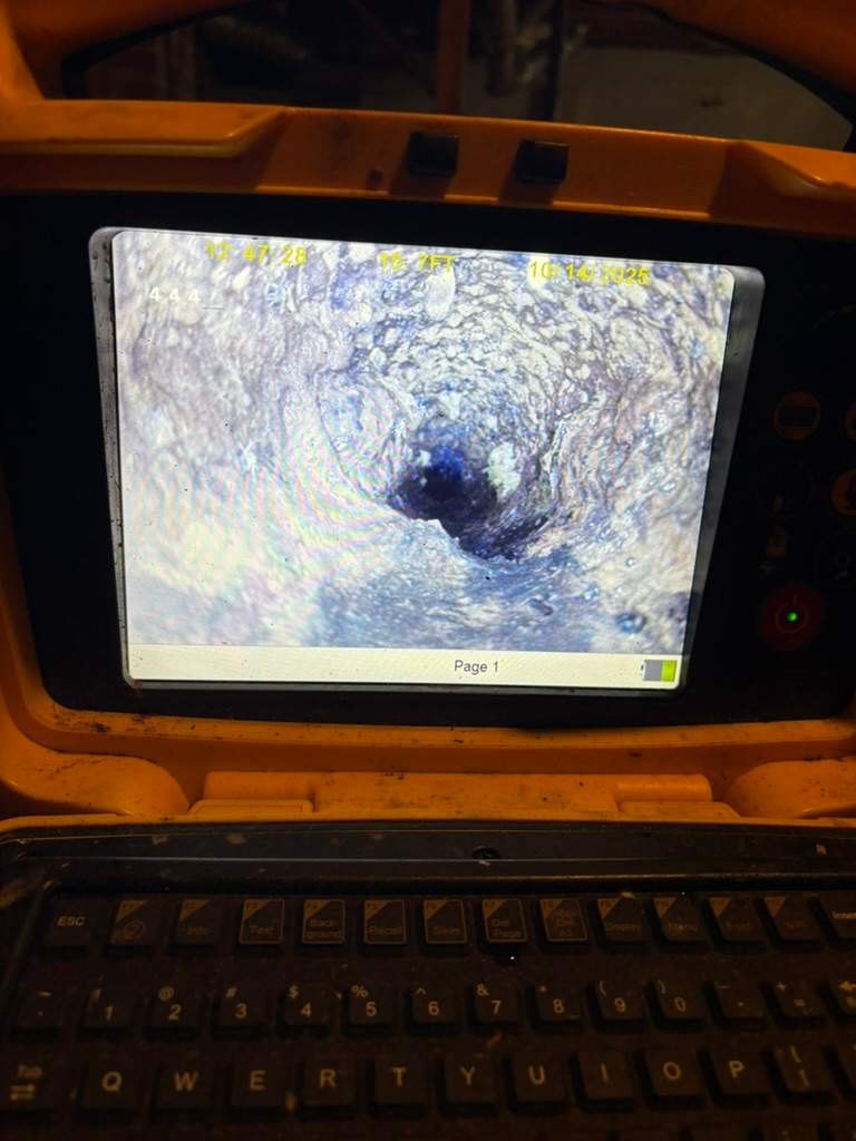 LiningWorks technician running a sewer scope to evaluate scale buildup before pipe descaling.
