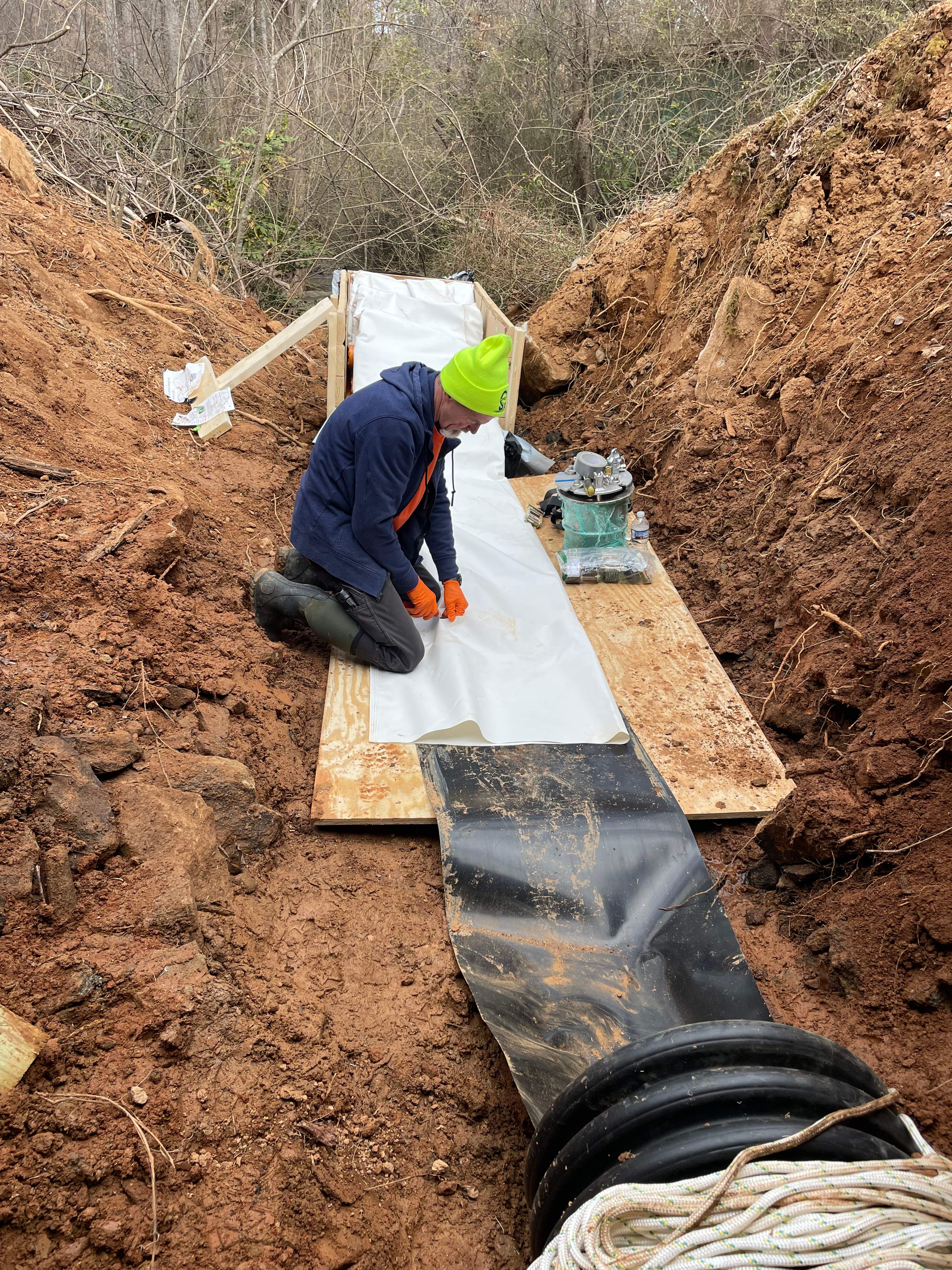 LiningWorks Trenchless Pipe Repair & Sewer Pipe Lining technician preparing a CIPP liner in a trench in Wilkesboro, NC.
