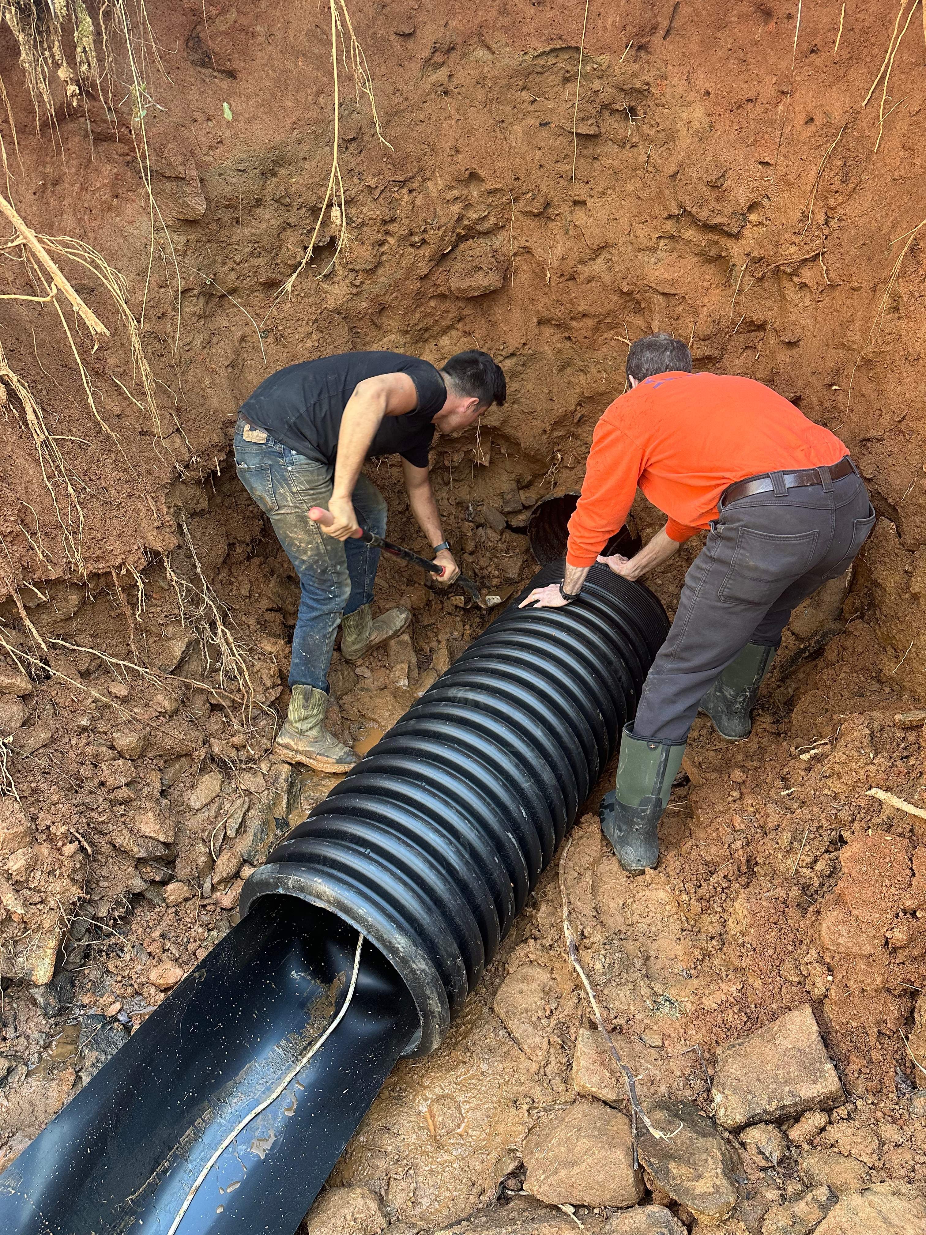 CIPP liner sealing storm drain joints causing sinkhole formation near parking lot drain.