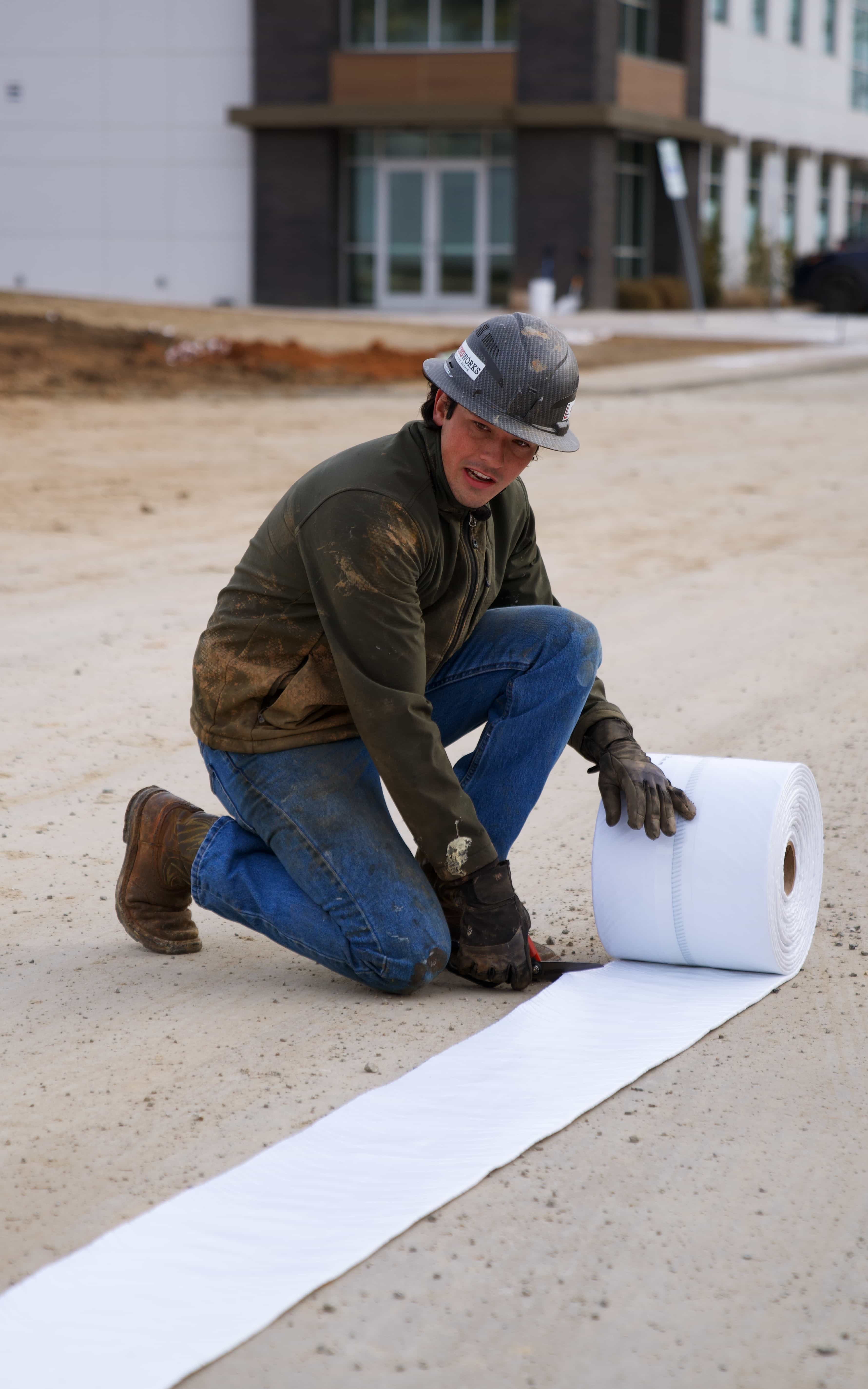 LiningWorks crew member installing pipe lining material on the job site.