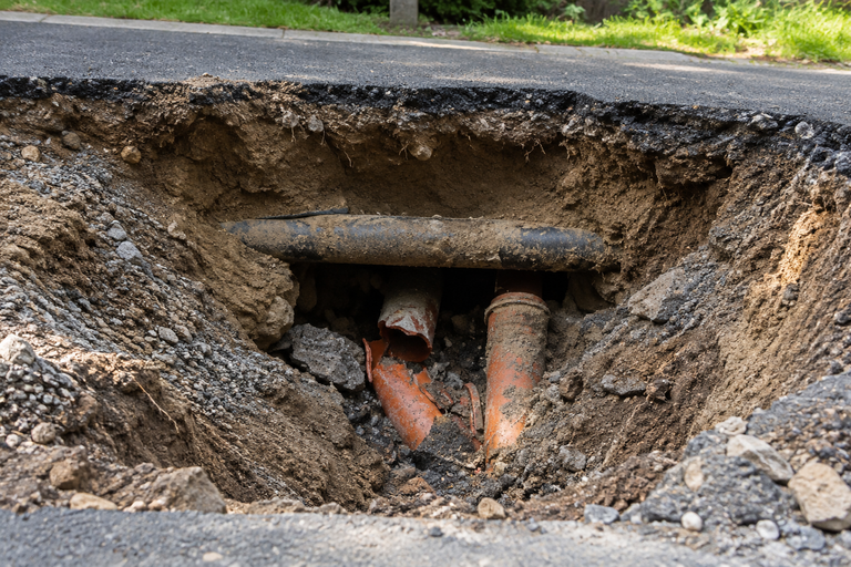 LiningWorks crew rehabilitating storm drain pipe causing sinkhole formation at commercial property.